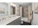 Bathroom features dual sinks, gray vanity, and a shower-tub with neutral tile at 5273 Glenridge Dr # 5273, Sandy Springs, GA 30342
