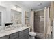 Bathroom featuring double sinks, shower with tile, and framed art on the walls at 5273 Glenridge Dr # 5273, Sandy Springs, GA 30342