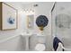 Bright bathroom with pedestal sink, glass shower, and decorative wall accents at 5273 Glenridge Dr # 5273, Sandy Springs, GA 30342