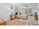 Bright bedroom featuring a ceiling fan, wood floors, and a decorative rug in a neutral palette at 5273 Glenridge Dr # 5273, Sandy Springs, GA 30342