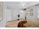 Spacious bedroom with wood floors, ceiling fan, and two large doors leading to closets at 5273 Glenridge Dr # 5273, Sandy Springs, GA 30342