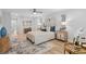 Bright bedroom featuring a ceiling fan, wood floors, a decorative rug and light neutral paint at 5273 Glenridge Dr # 5273, Sandy Springs, GA 30342