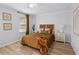 Bedroom with wood floors and tan striped comforter, and neutral wall art at 5273 Glenridge Dr # 5273, Sandy Springs, GA 30342