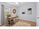 Cozy bedroom with a desk, chair, natural light, and wood-look flooring at 5273 Glenridge Dr # 5273, Sandy Springs, GA 30342