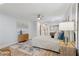 Bright bedroom featuring a ceiling fan, wood floors, neutral paint, and an area rug at 5273 Glenridge Dr # 5273, Sandy Springs, GA 30342