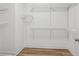 Bright, empty walk-in closet features wood floors, white walls and wire shelving at 5273 Glenridge Dr # 5273, Sandy Springs, GA 30342