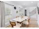 Dining area with modern white table, stylish chairs, and bright lighting at 5273 Glenridge Dr # 5273, Sandy Springs, GA 30342