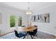 Dining room with backyard view through french doors and modern decor at 5273 Glenridge Dr # 5273, Sandy Springs, GA 30342