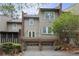 Townhome with brick base and neutral-colored siding, complemented by well-kept landscaping at 5273 Glenridge Dr # 5273, Sandy Springs, GA 30342