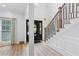 Bright entryway featuring hardwood floors, black door, modern staircase, and ample natural light at 5273 Glenridge Dr # 5273, Sandy Springs, GA 30342