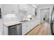 Galley kitchen featuring white cabinets and stainless steel appliances and fixtures at 5273 Glenridge Dr # 5273, Sandy Springs, GA 30342