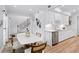 Bright kitchen and dining area featuring white cabinetry, stainless steel appliances, and modern finishes at 5273 Glenridge Dr # 5273, Sandy Springs, GA 30342
