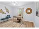 Bright home office with a desk and a decorative rug, bench seating and wood floors at 5273 Glenridge Dr # 5273, Sandy Springs, GA 30342