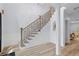 Elegant staircase showcasing modern black railings, white risers, and hardwood floors at 5273 Glenridge Dr # 5273, Sandy Springs, GA 30342