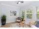 Bright sunroom features neutral decor, lots of windows, and a ceiling fan at 5273 Glenridge Dr # 5273, Sandy Springs, GA 30342