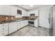 Functional kitchen with stainless steel appliances, ample counter space, and white cabinetry at 7282 Williamsburg Dr, Riverdale, GA 30274