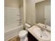 Bathroom featuring tub, toilet, and vanity with stone-look counter and undermount sink at 8120 Berrywood Ct, Covington, GA 30014
