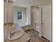 Bright bathroom with double sinks, granite counters, tiled floors, a shower, and a separate bathtub at 8120 Berrywood Ct, Covington, GA 30014