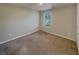 Standard bedroom with neutral carpet and view from a single window at 8120 Berrywood Ct, Covington, GA 30014
