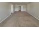 Large bedroom with neutral carpet and multiple interior doorways at 8120 Berrywood Ct, Covington, GA 30014