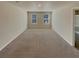 Expansive bedroom with neutral carpet, two windows and a view of an attached bathroom at 8120 Berrywood Ct, Covington, GA 30014