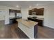 Modern kitchen featuring granite counters, stainless steel appliances, a central island, and dark wood cabinetry at 8120 Berrywood Ct, Covington, GA 30014