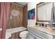 Stylish bathroom with tub, wooden-style tiled walls, and grey vanity with marble countertop at 1459 Village Park Ct, Atlanta, GA 30319