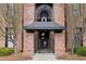 Building entrance with arched nameplate, metal gate and brick facade at 1459 Village Park Ct, Atlanta, GA 30319