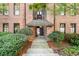 Exterior entrance to building with manicured bushes on either side and brick entryway at 1459 Village Park Ct, Atlanta, GA 30319