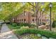 Tree covered exterior with red brick and black framed windows, surrounded by manicured lawn at 1459 Village Park Ct, Atlanta, GA 30319