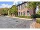 Brick apartment building with parking lot and green trees in front at 1459 Village Park Ct, Atlanta, GA 30319