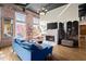 Spacious living room with fireplace, hardwood floors, and exposed brick accent wall at 1459 Village Park Ct, Atlanta, GA 30319