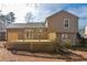 View of the back of the house showcasing a spacious backyard and wooden deck at 1614 Carrie Farm Ct, Kennesaw, GA 30144