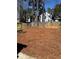 Spacious backyard with a wooden fence, offering privacy and a natural setting at 1614 Carrie Farm Ct, Kennesaw, GA 30144