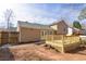 View of the back of the house showcasing a spacious backyard and wooden deck at 1614 Carrie Farm Ct, Kennesaw, GA 30144