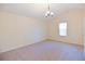 Bedroom with vaulted ceiling and neutral carpeting features a window bringing in natural light at 1614 Carrie Farm Ct, Kennesaw, GA 30144