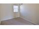 A bright bedroom with neutral carpeting features a window bringing in natural light at 1614 Carrie Farm Ct, Kennesaw, GA 30144