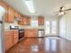 Well-lit kitchen featuring stainless steel appliances and rich wood flooring at 1614 Carrie Farm Ct, Kennesaw, GA 30144