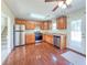 Bright kitchen with stainless steel appliances, wood floors, and ample cabinet space at 1614 Carrie Farm Ct, Kennesaw, GA 30144