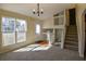 Inviting living room featuring new carpet, a large window, and access to the stairway at 1614 Carrie Farm Ct, Kennesaw, GA 30144