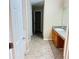 Bathroom with tiled floor, sink vanity, and hallway access to the walk-in closet at 3308 Hunting Creek Pass, Douglasville, GA 30135