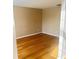 Small bedroom with hardwood floors, neutral walls and one window showing a bright living space at 3308 Hunting Creek Pass, Douglasville, GA 30135