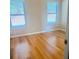 Cozy bedroom with hardwood floors and two large windows for natural light at 3308 Hunting Creek Pass, Douglasville, GA 30135