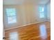 Bright bedroom with hardwood floors and natural light from windows at 3308 Hunting Creek Pass, Douglasville, GA 30135