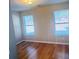 Bedroom featuring hardwood floors and two windows at 3308 Hunting Creek Pass, Douglasville, GA 30135