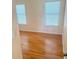 Bedroom with hardwood floors, windows with blinds, and neutral wall paint at 3308 Hunting Creek Pass, Douglasville, GA 30135