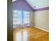 Bedroom with hardwood floors, purple accent, and natural light from the window at 3308 Hunting Creek Pass, Douglasville, GA 30135
