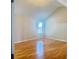 Bright bedroom features a window with natural light and beautiful wood flooring at 3308 Hunting Creek Pass, Douglasville, GA 30135