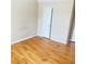 Bedroom with hardwood flooring; a door leads to another room or closet at 3308 Hunting Creek Pass, Douglasville, GA 30135