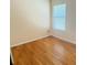 Bedroom with hardwood floors, window with blinds, and neutral wall paint at 3308 Hunting Creek Pass, Douglasville, GA 30135